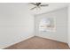 This bedroom has neutral carpet, a ceiling fan, and a large window at 540 W La Donna Dr, Tempe, AZ 85283