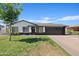 Charming single-story home with a well-maintained lawn, mature tree, and dark-colored garage at 540 W La Donna Dr, Tempe, AZ 85283