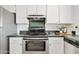 Close up of stainless steel oven and cooktop with granite countertop and decorative backsplash at 540 W La Donna Dr, Tempe, AZ 85283