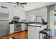 Bright kitchen features stainless steel appliances, granite countertops, and a breakfast bar with seating at 540 W La Donna Dr, Tempe, AZ 85283