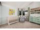 This bright Bedroom boasts a crib, comfortable glider, decor, and changing table at 5624 W Villa Theresa Dr, Glendale, AZ 85308