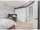 This bedroom features neutral walls, desk space, and a closet with sliding doors at 5624 W Villa Theresa Dr, Glendale, AZ 85308