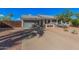 Charming single-story home with desert landscaping, two small trees, and a two-car garage at 5624 W Villa Theresa Dr, Glendale, AZ 85308