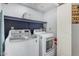The laundry room includes a front load washer and dryer, and built-in shelving at 5624 W Villa Theresa Dr, Glendale, AZ 85308