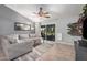 Spacious living room featuring a ceiling fan, sliding glass doors and stylish decor at 5624 W Villa Theresa Dr, Glendale, AZ 85308