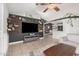 Open-concept living room with modern shelving and views to dining area at 5624 W Villa Theresa Dr, Glendale, AZ 85308
