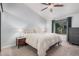 Bright main bedroom with a ceiling fan, large window and closet space at 5624 W Villa Theresa Dr, Glendale, AZ 85308