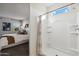 Bright bathroom with large walk-in shower, window, and views into the main bedroom at 5806 E Axle Ln, San Tan Valley, AZ 85140