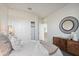 Bright bedroom showcasing neutral tones, natural light, a full closet, and a decorative mirror at 5806 E Axle Ln, San Tan Valley, AZ 85140