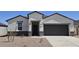 Charming single-story home with a two-car garage, desert landscaping, and a covered entryway at 5806 E Axle Ln, San Tan Valley, AZ 85140