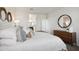 Comfortable main bedroom featuring a plush bed, accent wall, soft lighting, and tasteful decor for a relaxing retreat at 5806 E Axle Ln, San Tan Valley, AZ 85140