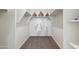 Bright walk-in closet features built-in shelving, carpeted floors, and a clothing rod for optimal organization at 5806 E Axle Ln, San Tan Valley, AZ 85140