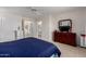Cozy bedroom with views to the ensuite bathroom and closet, with a dresser with an attached mirror at 5830 E Mckellips Rd # 101, Mesa, AZ 85215