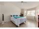 Spacious bedroom with tiled floors, a ceiling fan, and a bright window with views of the yard at 5830 E Mckellips Rd # 101, Mesa, AZ 85215