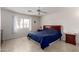 Comfortable bedroom with neutral walls, tiled floors, and a large window providing ample natural light at 5830 E Mckellips Rd # 101, Mesa, AZ 85215