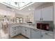 Well-lit kitchen with white cabinetry and appliances, seamlessly connecting to the dining and living areas at 5830 E Mckellips Rd # 101, Mesa, AZ 85215