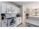 Bright kitchen with white cabinets, modern appliances, and an open layout to the breakfast nook at 5830 E Mckellips Rd # 101, Mesa, AZ 85215