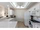 Bright kitchen with white appliances, tiled floors, and an open layout to other living spaces at 5830 E Mckellips Rd # 101, Mesa, AZ 85215