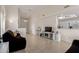 Bright living room showcasing tile flooring, ceiling fan, and partial view into the kitchen area at 5830 E Mckellips Rd # 101, Mesa, AZ 85215