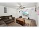 Cozy living room featuring new flooring, a ceiling fan, and a entertainment area at 5923 W Townley Ave, Glendale, AZ 85302
