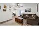 Inviting living room and kitchen featuring stylish laminate flooring, ceiling fan, and office space at 5923 W Townley Ave, Glendale, AZ 85302
