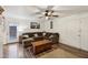 Welcoming living room with ample seating, natural light, and stylish wood-look laminate floors at 5923 W Townley Ave, Glendale, AZ 85302