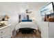 Well-lit main bedroom featuring updated flooring and a ceiling fan at 5923 W Townley Ave, Glendale, AZ 85302
