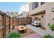 Cozy patio area featuring a wooden fence, comfortable couch, coffee table, and potted plants for a relaxing outdoor space at 5923 W Townley Ave, Glendale, AZ 85302