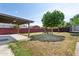 Large backyard with a play structure, trampoline, patio, and mature tree at 6814 N 14Th St, Phoenix, AZ 85014