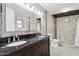 Remodeled bathroom with a walk-in shower, double sink vanity, and neutral tile at 6814 N 14Th St, Phoenix, AZ 85014