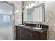 Bathroom with tiled walls, dual sink vanity, and seamless access to the main bedroom at 6814 N 14Th St, Phoenix, AZ 85014