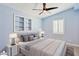 Cozy bedroom featuring a ceiling fan, built-in shelving, neutral tones, and comfortable furnishings for restful sleep at 6814 N 14Th St, Phoenix, AZ 85014