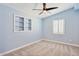 Bedroom featuring neutral-toned walls, plush carpet, a ceiling fan, and built-in shelving at 6814 N 14Th St, Phoenix, AZ 85014