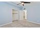 Bedroom with blue walls, plush carpeting, a ceiling fan, and ample closet space at 6814 N 14Th St, Phoenix, AZ 85014