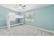 This bedroom has a bunk bed with white frames, complemented by soft gray carpeting and a ceiling fan at 6814 N 14Th St, Phoenix, AZ 85014