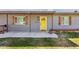 Charming home featuring a bright yellow front door, decorative shutters, and a covered front patio for welcoming guests at 6814 N 14Th St, Phoenix, AZ 85014