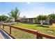 Charming home exterior featuring a well-kept lawn and a welcoming yellow front door at 6814 N 14Th St, Phoenix, AZ 85014