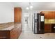 Updated kitchen features a large stainless steel refrigerator, granite counters, and plenty of storage space at 6814 N 14Th St, Phoenix, AZ 85014