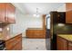 Stylish kitchen with granite countertops, wooden cabinets and stainless steel refrigerator at 6814 N 14Th St, Phoenix, AZ 85014