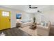 Bright living room with hardwood floors, modern ceiling fans, comfortable seating, and natural light from the window at 6814 N 14Th St, Phoenix, AZ 85014