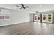 Spacious living room with wood-look floors, recessed lighting, and multiple ceiling fans at 6814 N 14Th St, Phoenix, AZ 85014