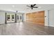 Open concept living room boasts wood-look floors, French doors, and a rustic wood accent wall at 6814 N 14Th St, Phoenix, AZ 85014