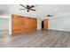 Large living room has stylish flooring, wood accent wall, and sliding barn door for a rustic touch at 6814 N 14Th St, Phoenix, AZ 85014