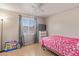 Bedroom with tile floors, neutral paint, a window, and a ceiling fan at 6960 W Berkeley Rd, Phoenix, AZ 85035