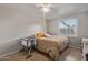 Sunlit bedroom features a ceiling fan, neutral paint, and a tile floor at 6960 W Berkeley Rd, Phoenix, AZ 85035