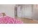 Bedroom includes an open closet with bi-fold doors and tile floors at 6960 W Berkeley Rd, Phoenix, AZ 85035