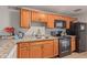 Updated kitchen features granite countertops, wood cabinets, and tile floors at 6960 W Berkeley Rd, Phoenix, AZ 85035