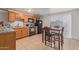Eat-in kitchen features wooden cabinets, tile floors, and stainless steel appliances at 6960 W Berkeley Rd, Phoenix, AZ 85035