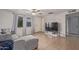 Bright living room with tile floors, ceiling fan, and access to the front door at 6960 W Berkeley Rd, Phoenix, AZ 85035