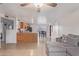 Open-concept living room with tile floors, ceiling fan, and view to the dining area at 6960 W Berkeley Rd, Phoenix, AZ 85035